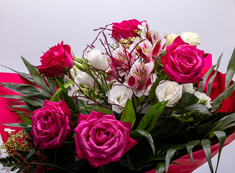 Beautiful pink rose and alstroemeria flowers in a bouquet on soft background