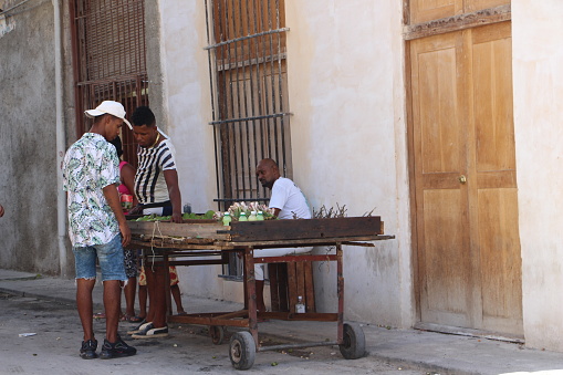 cuba - la havana - old havana -August 7, 2019\n street seller in an old street of old Havana and aclient who is chosing the merchandise