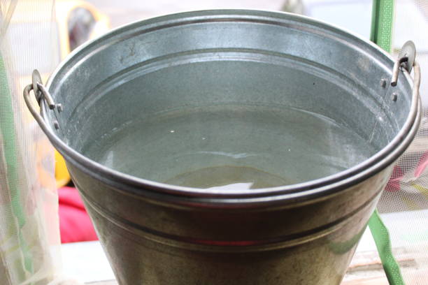 istock metal bucket with water close-up 1440992335