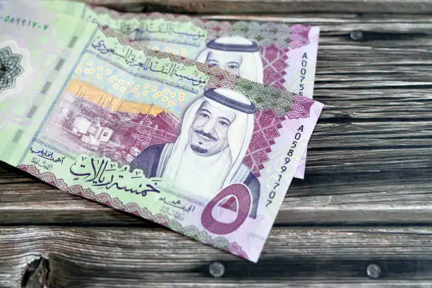 Obverse side of the new polymer 5 SAR five Saudi Arabia riyals cash money banknote bill series 1441 AH features Shaybah oil refinery in Rub' al Khali and king Salman Bin AbdulAziz Al Saud, selective focus