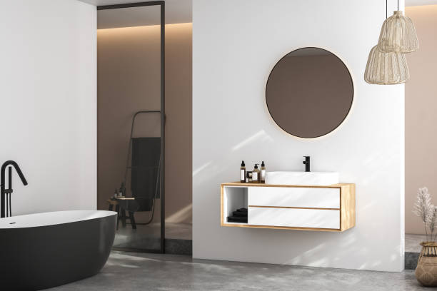 istock Modern minimalist bathroom interior, modern bathroom cabinet, white sink, wooden vanity, interior plants, bathroom accessories, bathtub and shower, white and beige walls, concrete floor. 3d rendering 1440993811