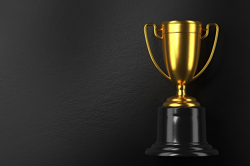 Winning a Championship Concept Golden Trophy Cup with Star Shaped Confetti. 3D Render