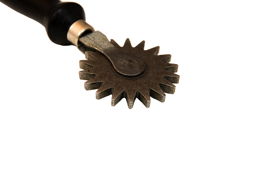 Antique spiked rolling wheel leather tracing tool.