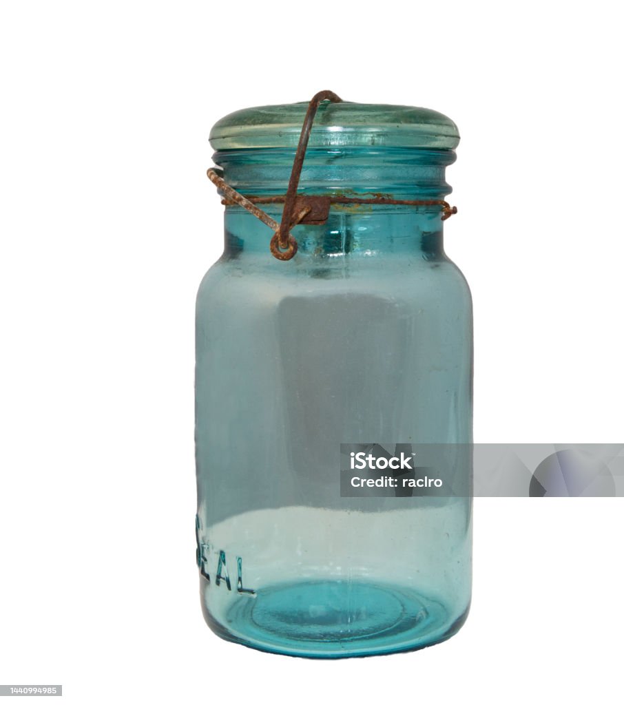 Antique blue/ green glass canning jar with rusted wire cap locking mechanism Antique Stock Photo
