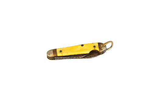 Antique heavily used and rusted pocket knife with yellow handle.