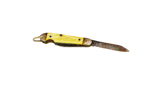 Folding pocket knife with wooden handle. A small knife on a wooden surface.