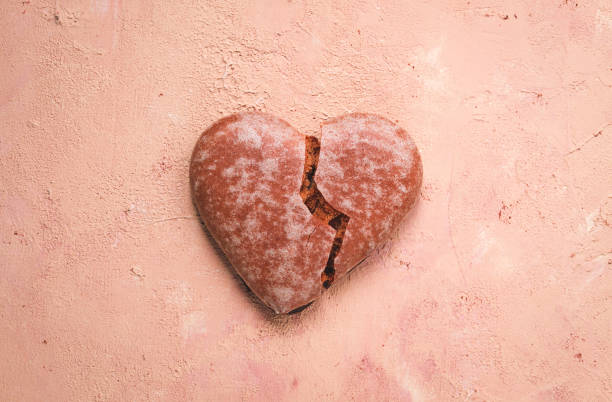 istock Glazed chocolate gingerbread, heart-shaped, top view, close-up, a broken heart, on beige background, no people, 1440996356