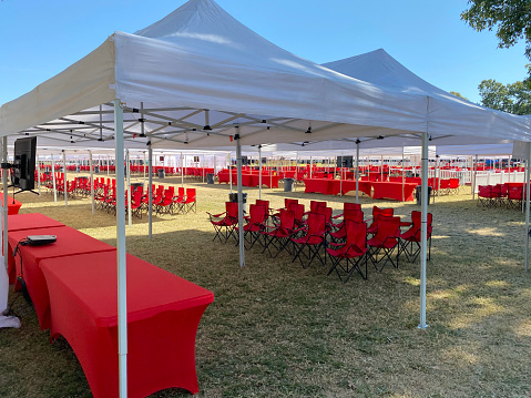 Tailgating setup with tents and chairs on campus