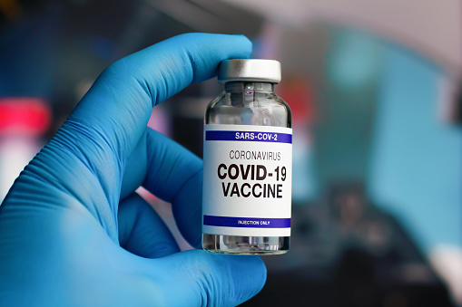 Covid-19 or coronavirus vaccine vial for immunization against virus mutation. Doctor with vial of the coronavirus sars-cov-2 vaccine for vaccination of the population