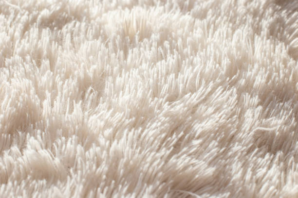 Texture of fluffy white artificial plaid, close up Texture of fluffy white artificial plaid. Close up shaggy fur stock pictures, royalty-free photos & images