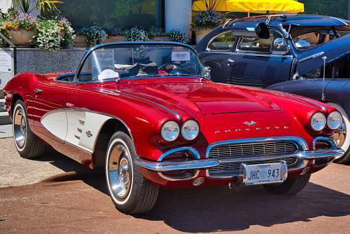 Baden-Baden, Germany - 10 July 2022: red white Chevrolet Corvette C1 Convertible cabrio 1958 is parked in Kurpark in Baden-Baden at the exhibition of old cars \