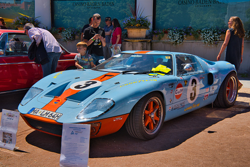 Baden-Baden, Germany - 10 July 2022: light blue orange Ford GT40 GT sport racing car is parked in Kurpark in Baden-Baden at the exhibition of old cars 