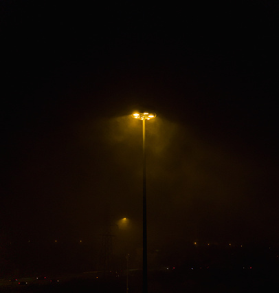 Highway lamppost on a foggy night
