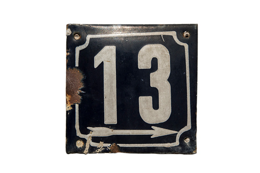 Weathered grunge square metal enameled plate of number of street address with number 13 isolated on white background