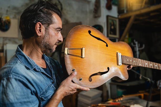 istock A luthier checks an hollow body guitar neck in his workshop to verify alignment 1441009571