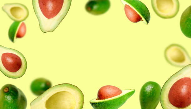 Background of juicy ripe avocados. Levitating avocados on a light background