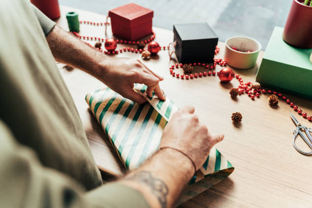 istock Man is preparing gift packages for Christmas 1441010906