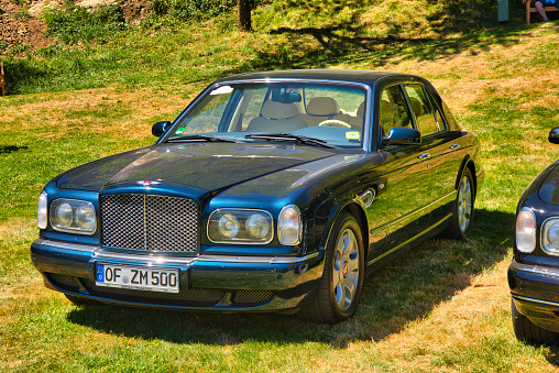 Baden-Baden, Germany - 10 July 2022: blue Bentley Arnage Green Label 1998 is parked in Kurpark in Baden-Baden at the exhibition of old cars \