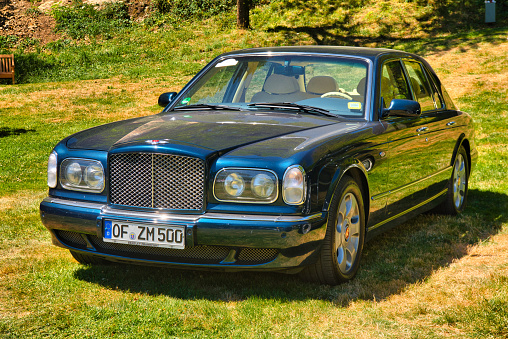 Baden-Baden, Germany - 10 July 2022: blue Bentley Arnage Green Label 1998 is parked in Kurpark in Baden-Baden at the exhibition of old cars \