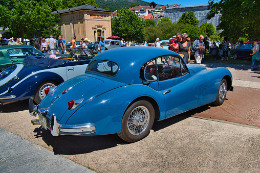 Baden-Baden, Germany - 10 July 2022: blue 1955 Jaguar XK140 Fixed Head Coupe is parked in Kurpark in Baden-Baden at the exhibition of old cars \