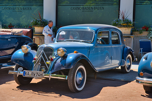 Baden-Baden, Germany - 10 July 2022: blue Citroen Traction Avant 1954 is parked in Kurpark in Baden-Baden at the exhibition of old cars \