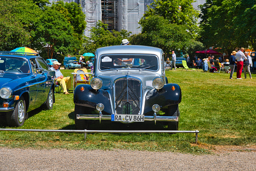 Baden-Baden, Germany - 10 July 2022: blue Citroen Traction Avant 1956 is parked in Kurpark in Baden-Baden at the exhibition of old cars \