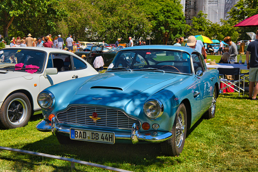 Baden-Baden, Germany - 10 July 2022: blue Aston Martin DB4 1960 is parked in Kurpark in Baden-Baden at the exhibition of old cars 