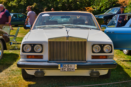 Baden-Baden, Germany - 10 July 2022: white Rolls-Royce Camargue 1975 is parked in Kurpark in Baden-Baden at the exhibition of old cars \