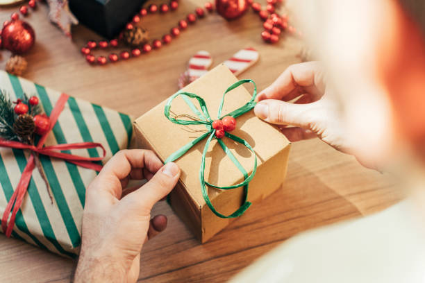istock Man is preparing gift packages for Christmas 1441014313