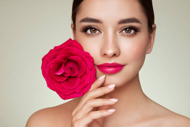istock Beautiful young woman a rose flower 1441014648