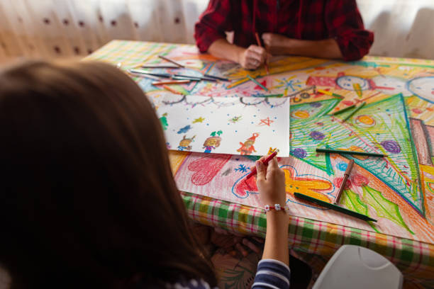 istock Family drawing and making a poster with a Christmas theme 1441015401