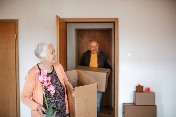 Senior couple moving in new apartment stock photo