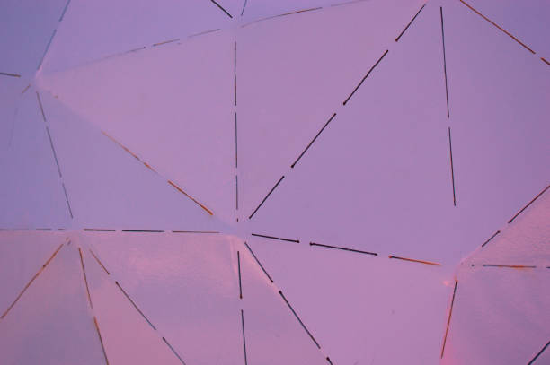 istock Close-up of a wall with pink metal triangles. Building element 1441016346