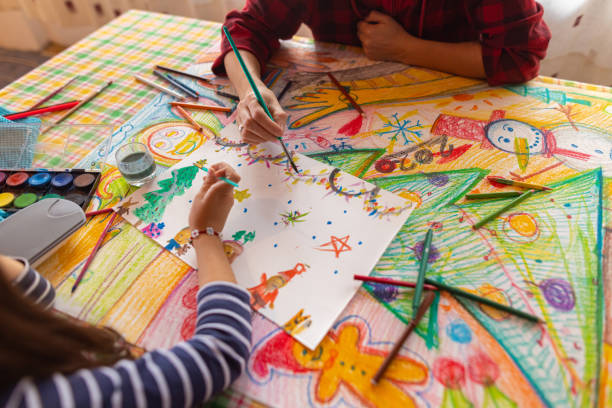 Creative girl and mother making a Christmas art