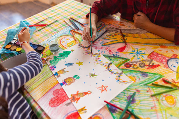 istock Creative girl and mother making a Christmas art 1441016412