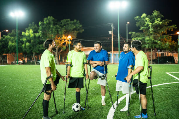 istock Amputee soccer players talking on soccer field 1441016609