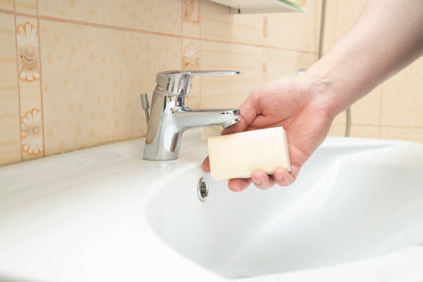 istock A man washes his hands with soap in the bathroom. 1441017304