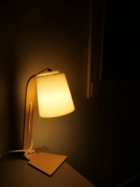 istock Lonely desk lamp, dark hotel room 1441017350