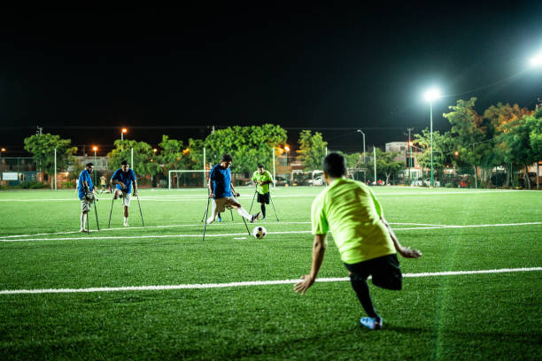 istock Young amputee player hitting penalty kick on soccer field 1441017782