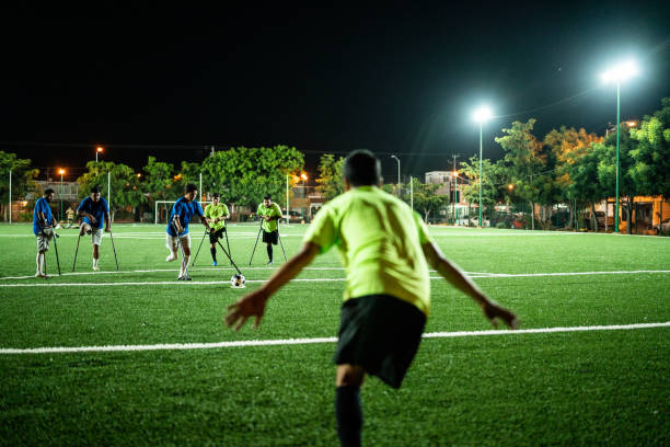 istock Young amputee player hitting penalty kick on soccer field 1441017805