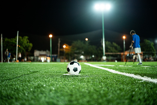 Close-up of a soccer ball on the penalty spot on soccer field