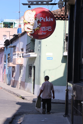 Cuba - La Havana - a man walking in havana's chinatown ( barrio chino )