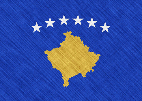 Flag of Kosovo on a textured background. Concept collage.