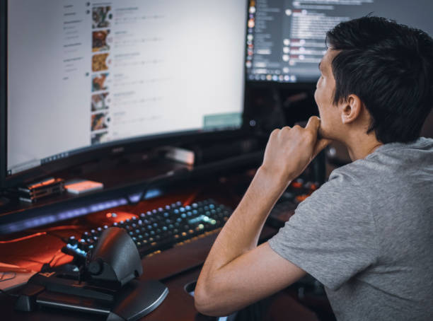 istock A young caucasian guy sits in a work chair and browses an online menu for ordering takeaway food 1441020474