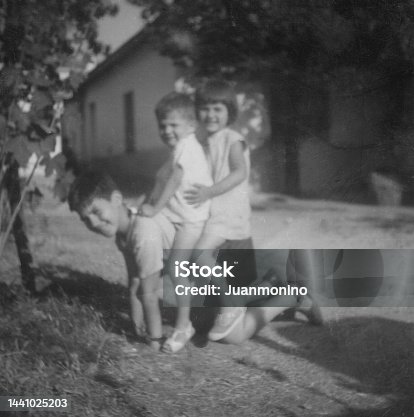 istock Black and white images taken in the 60s: Children posing playing outdoors 1441025203