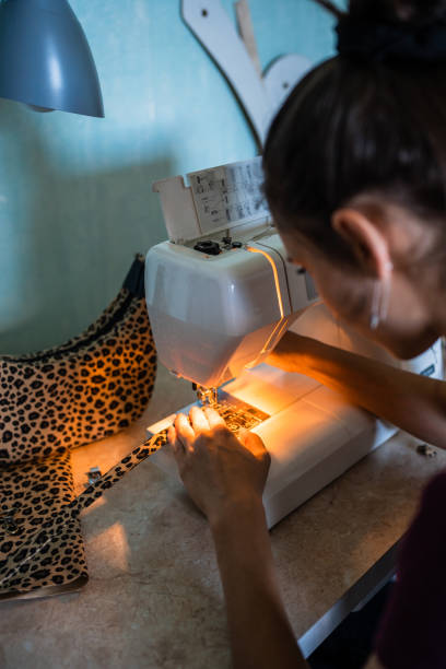 istock Young woman making bag with sewing machine. 1441025402