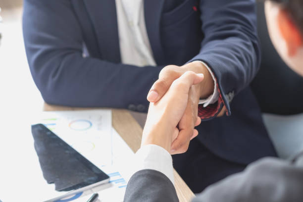 istock two business men shake hands for business cooperation 1441025960
