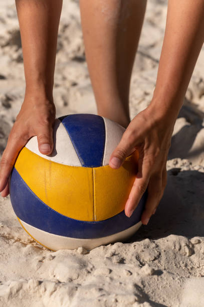 istock Women's hands lifting a volleyball ball 1441026731