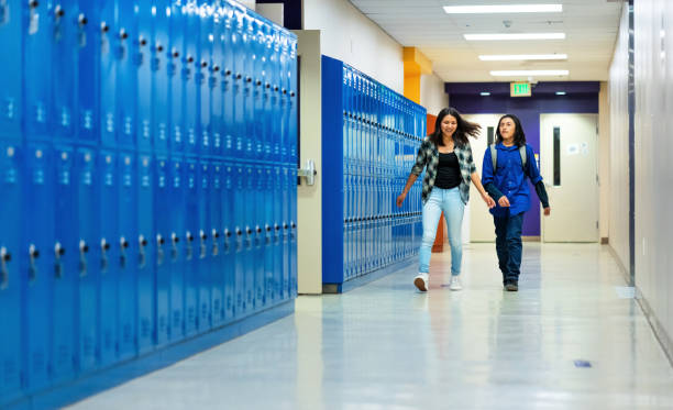 istock Kids getting put of the classroom walking on a corridor 1441027251