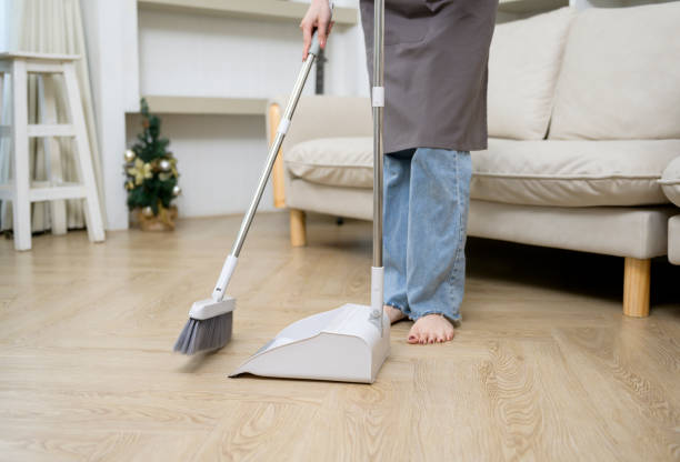 Happy Asian young woman sweeping the floor to cleaning house, healthy lifestyle concept stock photo